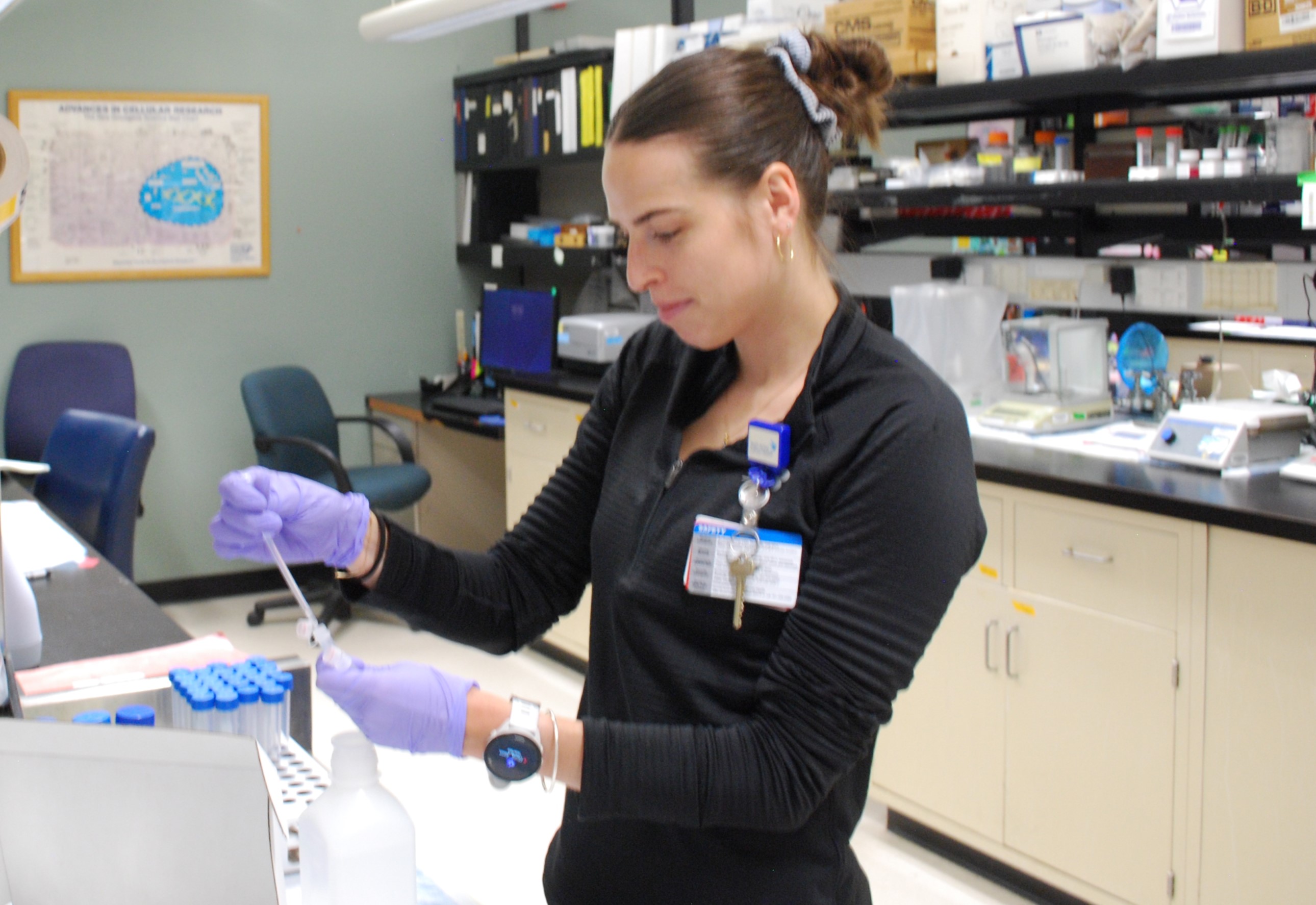 A woman pipetting blood