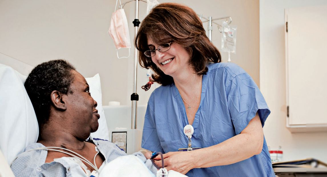 Dialysis nurse talking to a patient