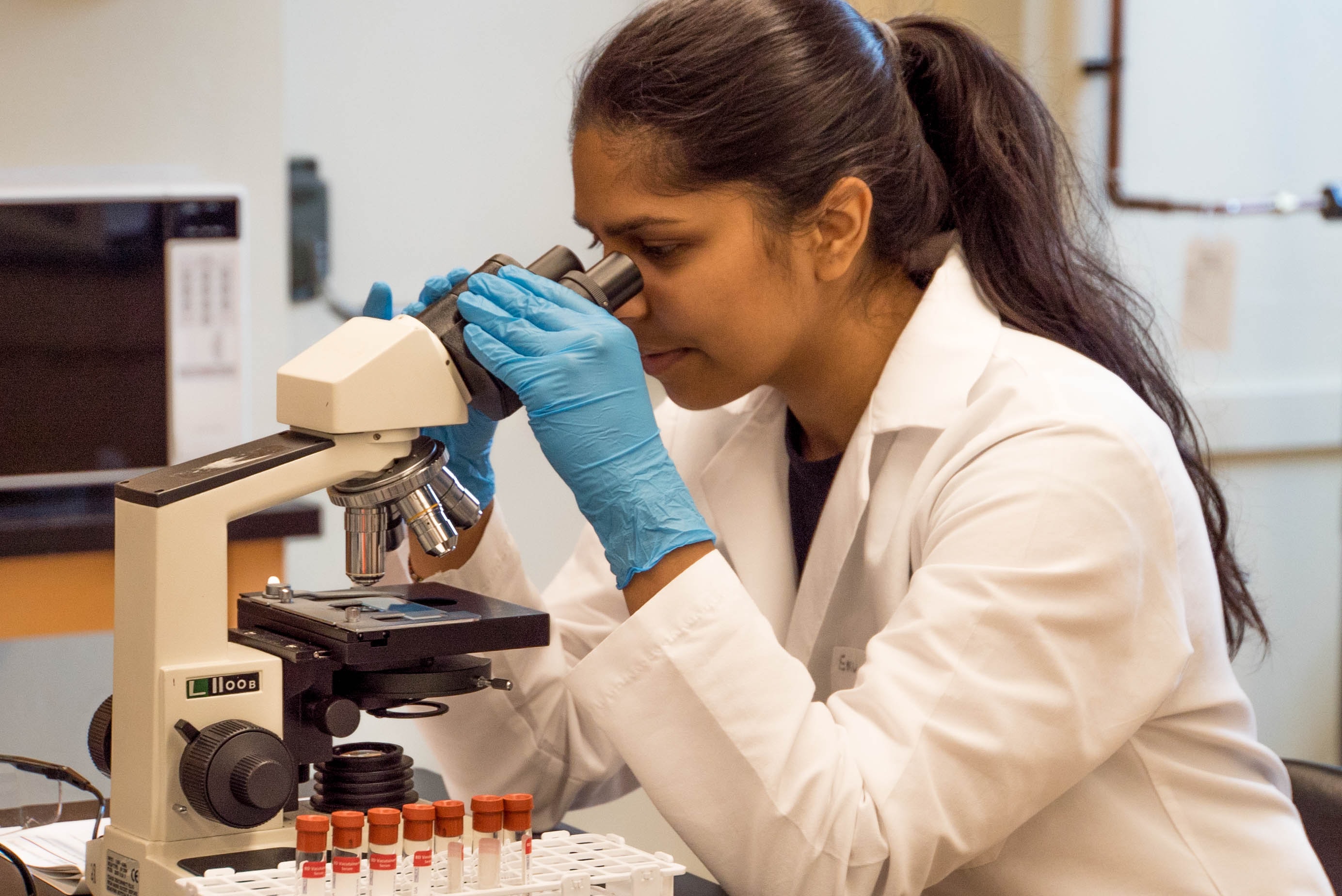 Woman scientist using microscope