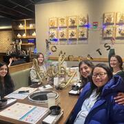 Group of women holding up signs that say &quot;Congrats&quot; and &quot;Baby.&quot;