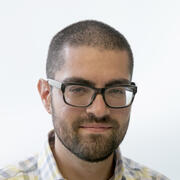 A professional headshot of Aaron Fleishman