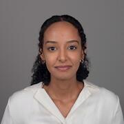 A professional headshot of Yulia Mulugeta