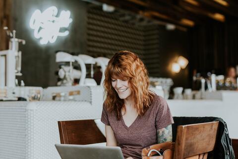woman using laptop in cafe