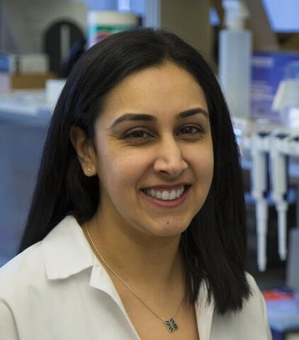 Dr. Aarti Asnani in lab coat smiling