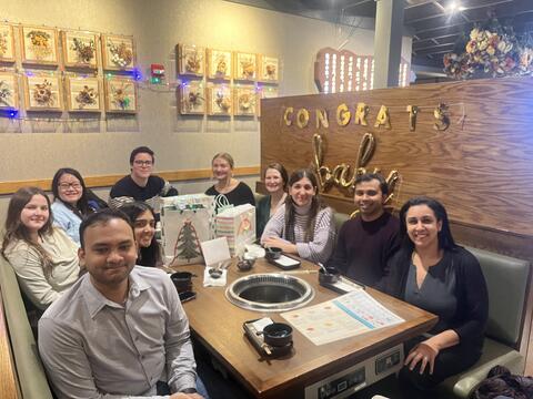 Group of people sitting around a table.