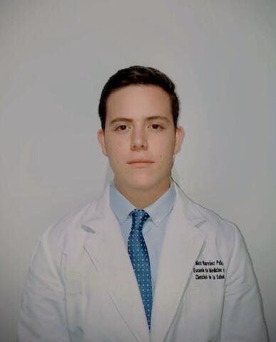 Max in a white lab coat in front of a white background.