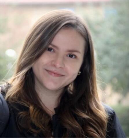 Monica smiling outside