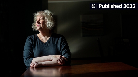 A Women Sitting at a Table Looking Off 