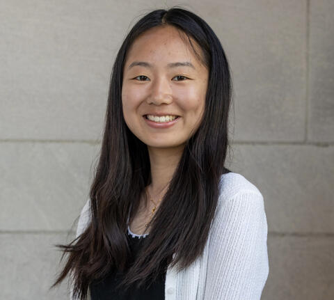 Alissa Wang smiling in front of a beige background