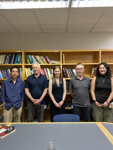 Professor McCloskey with lab members in meeting room
