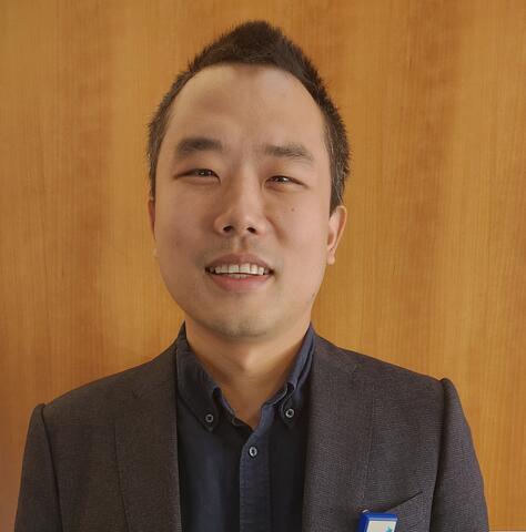 Dr. Qiu smiling at the news of his new grant to study vascular demetia