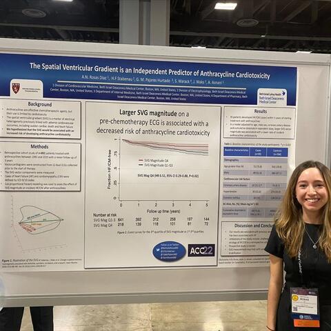 Woman standing in front of a board with a poster on it.