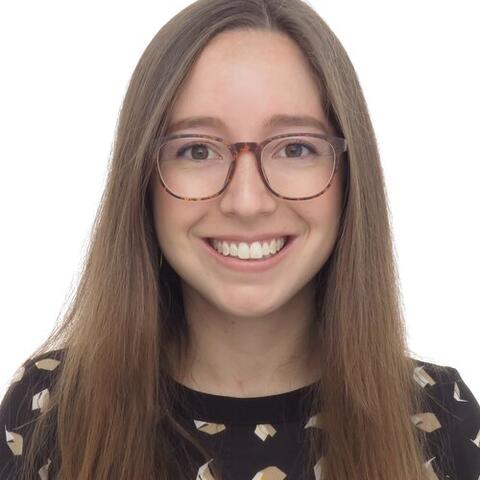 Nathalie smiling in front of a white background
