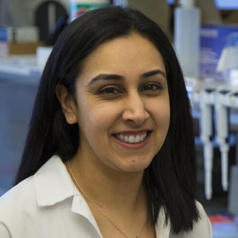 Dr. Aarti Asnani in lab coat smiling