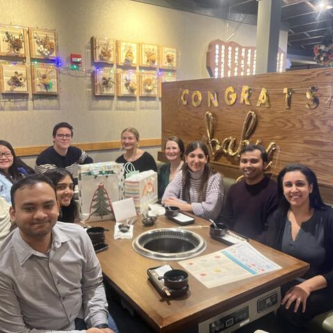 Group of people sitting around a table.