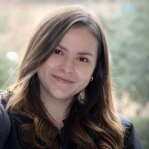 Monica smiling outside