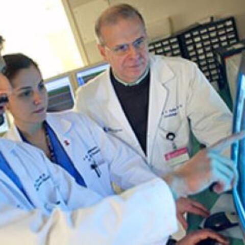 Doctors look at clinical image on hospital computer