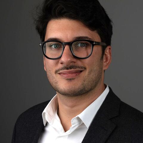 Photo of Dr. Maxime Lebaz wearing glasses and a suit