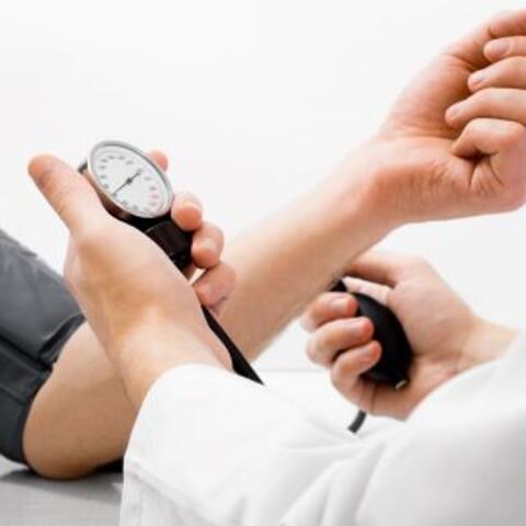 Doctor use cuff to measure blood pressure