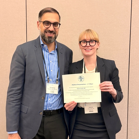 Dr. Helena Smith stands beside mentor Dr. Mohamad Hussain and holds up certificate of award for Top Abstract at VASA 2026