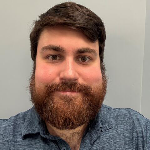 A headshot of Domenic Annand