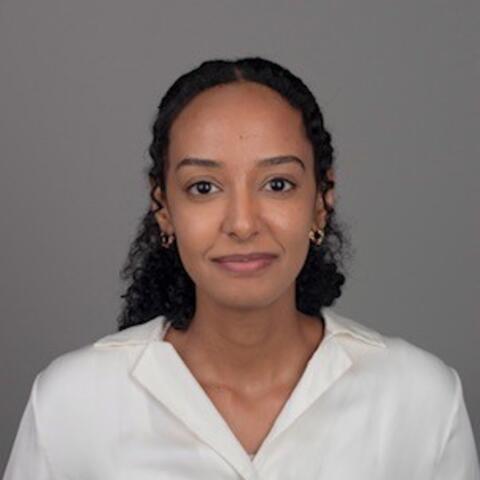 A professional headshot of Yulia Mulugeta