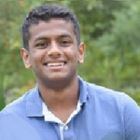 Anish smiling in a blue shirt