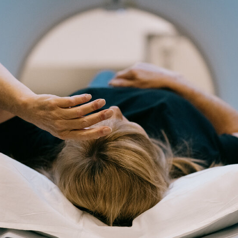 A Women Laying in a MRI Machine 
