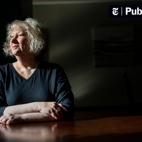 A Women Sitting at a Table Looking Off 