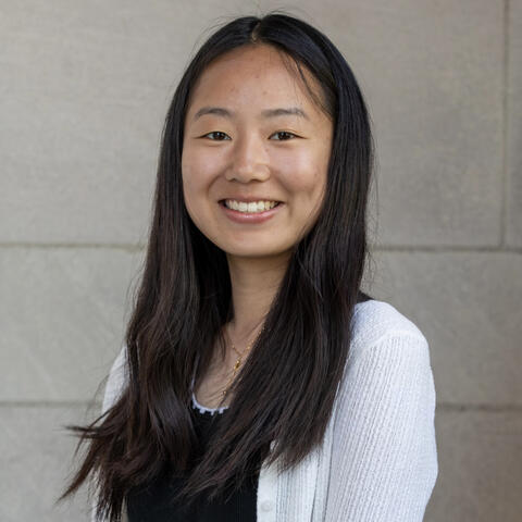 Alissa Wang smiling in front of a beige background