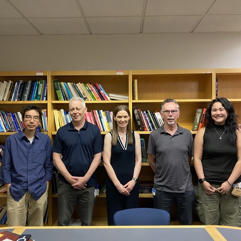 Professor McCloskey with lab members in meeting room