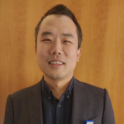 Dr. Qiu smiling at the news of his new grant to study vascular demetia