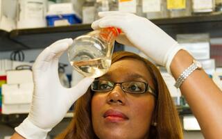 researcher with glass flask