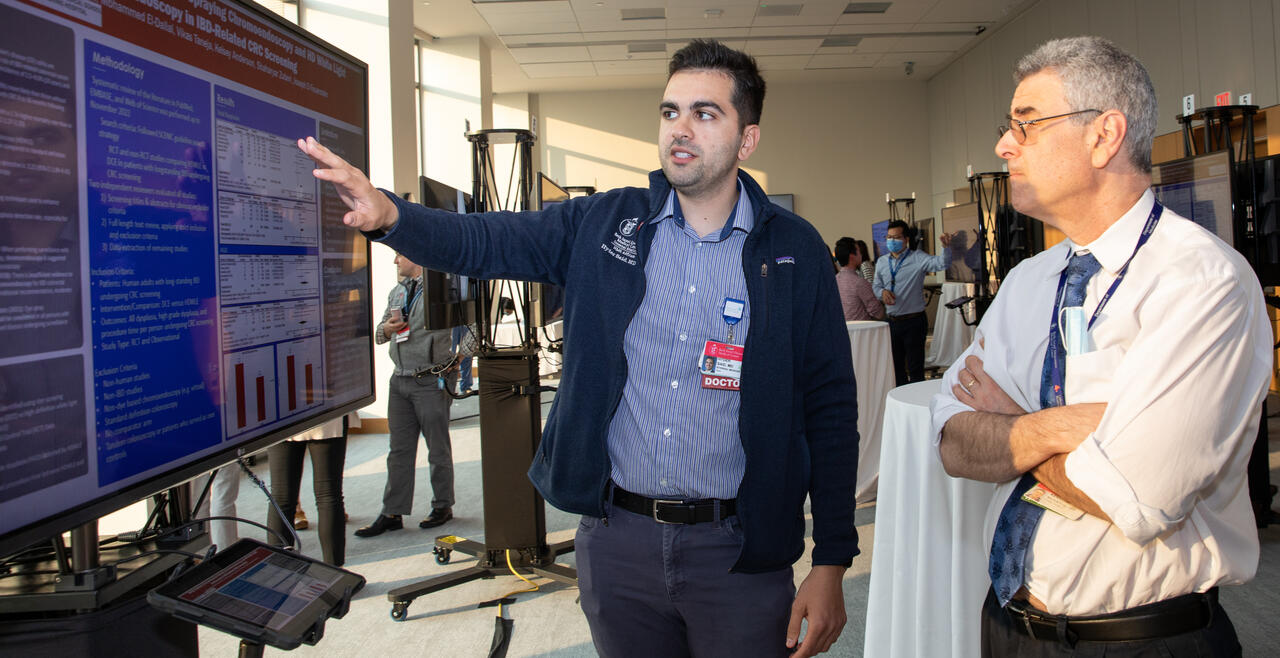 Resident presenting their work to Ken Mukamal