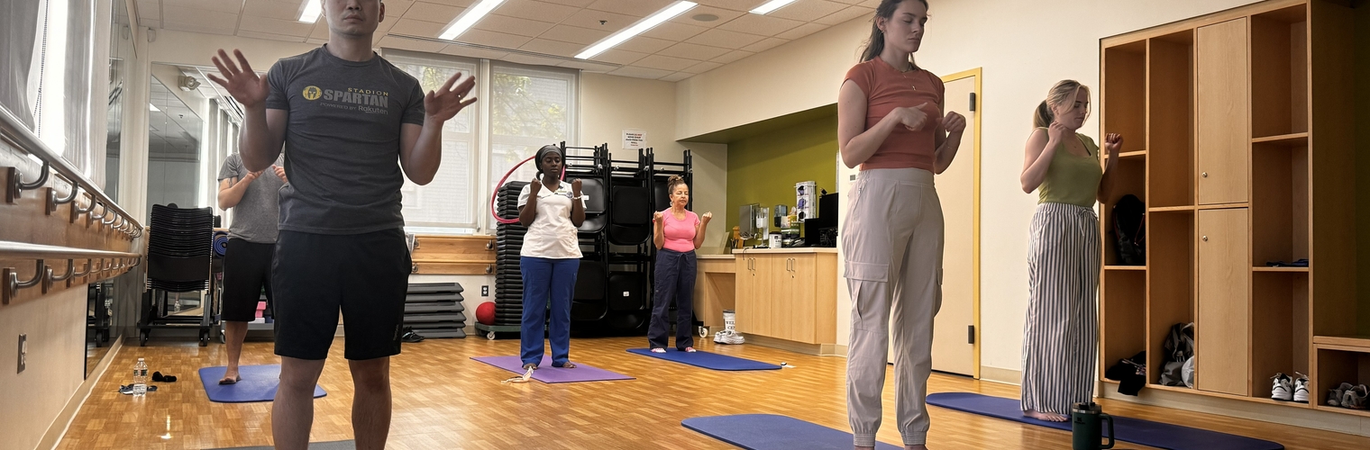 Bowdoin St. Health Center staff engaging in simple stretches
