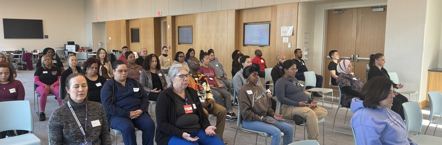 Healthcare workers practicing meditation during a workshop