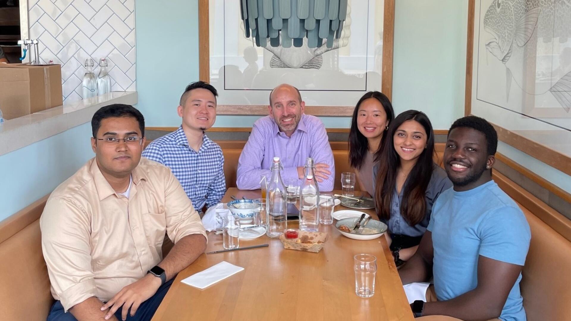 Benson lab members sitting together in a restaurant