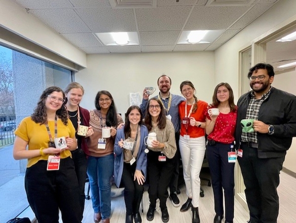 A group of fellows posing holding mugs during a "mug party"