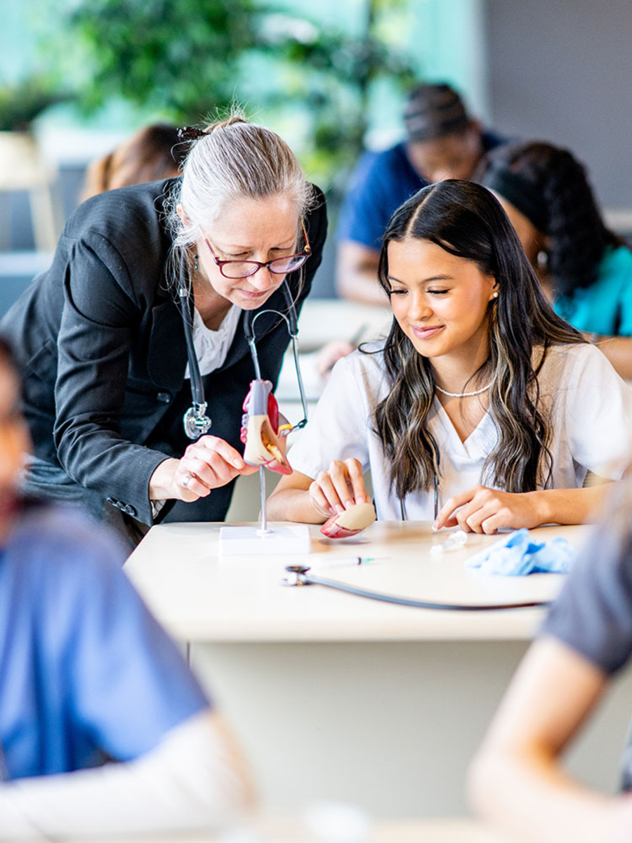 Doctor and student looking at hands in discussion